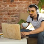 Remote Work-man on computer at home or coffee shop