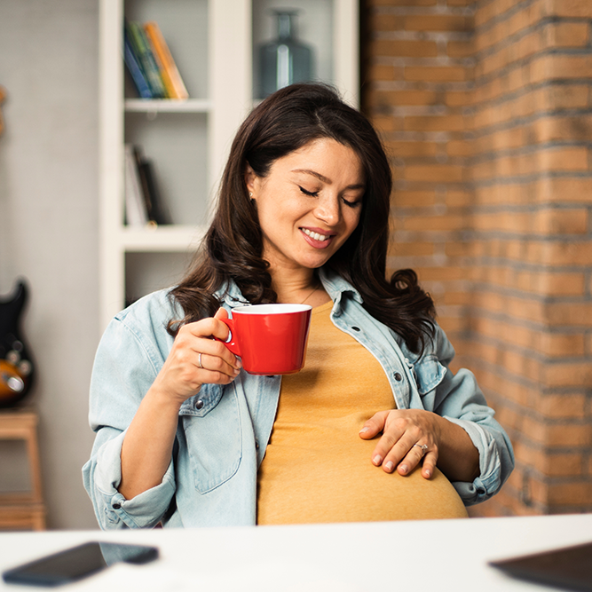 Pregnant woman at desk